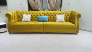 Blue couch and yellow Yellow and cushions.