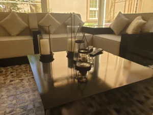 A well-furnished living room with a sofa and a modern coffee table.