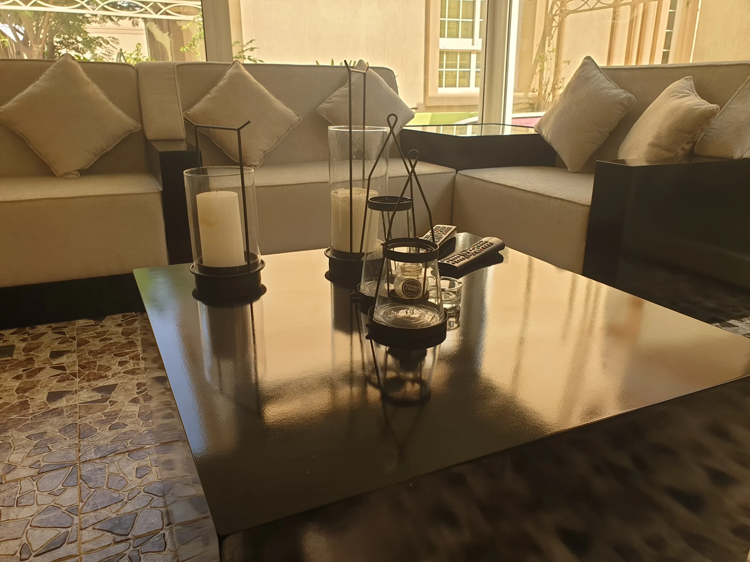 A well-furnished living room with a sofa and a modern coffee table.