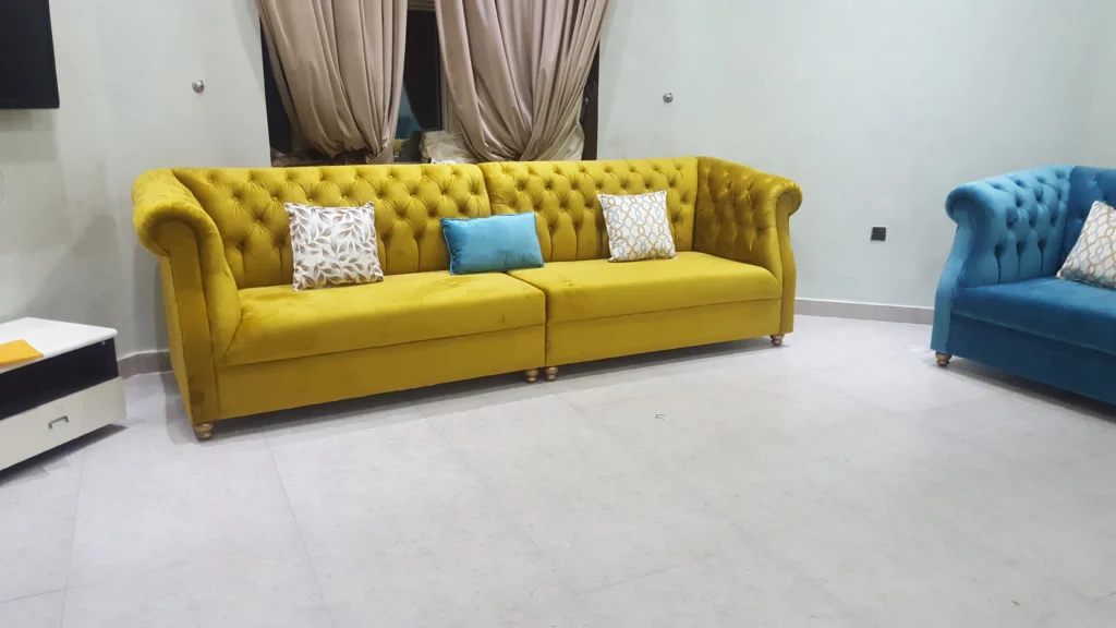Blue couch and yellow Yellow and cushions.